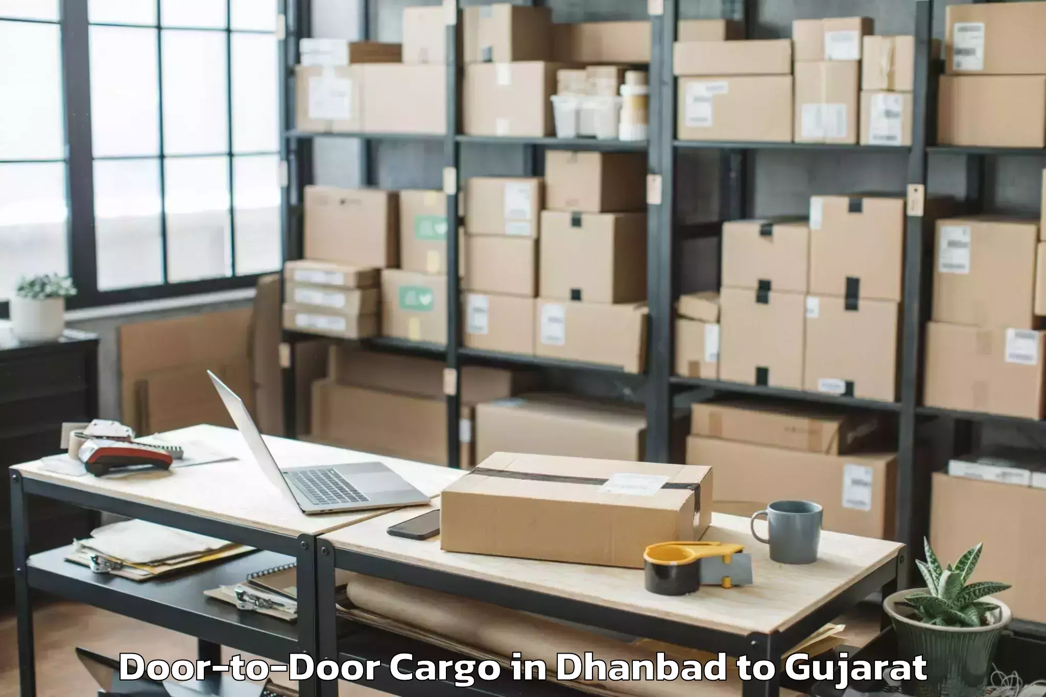 Professional Dhanbad to Kadi Sarva Vishwavidyalaya Gan Door To Door Cargo